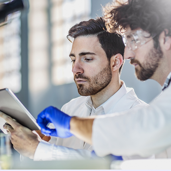 two scientist using digital tablet in laboratory
